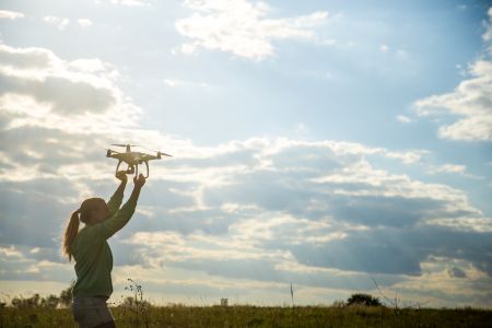 beautiful-girl-field-launches-drone-into-sky