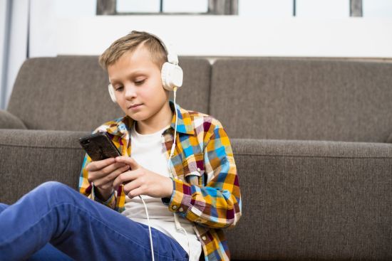 boy-with-headphones-using-smartphone