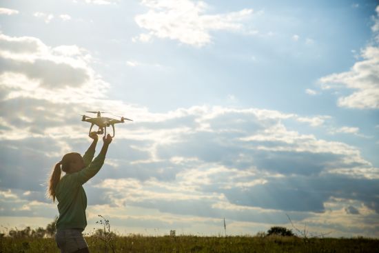 beautiful-girl-field-launches-drone-into-sky